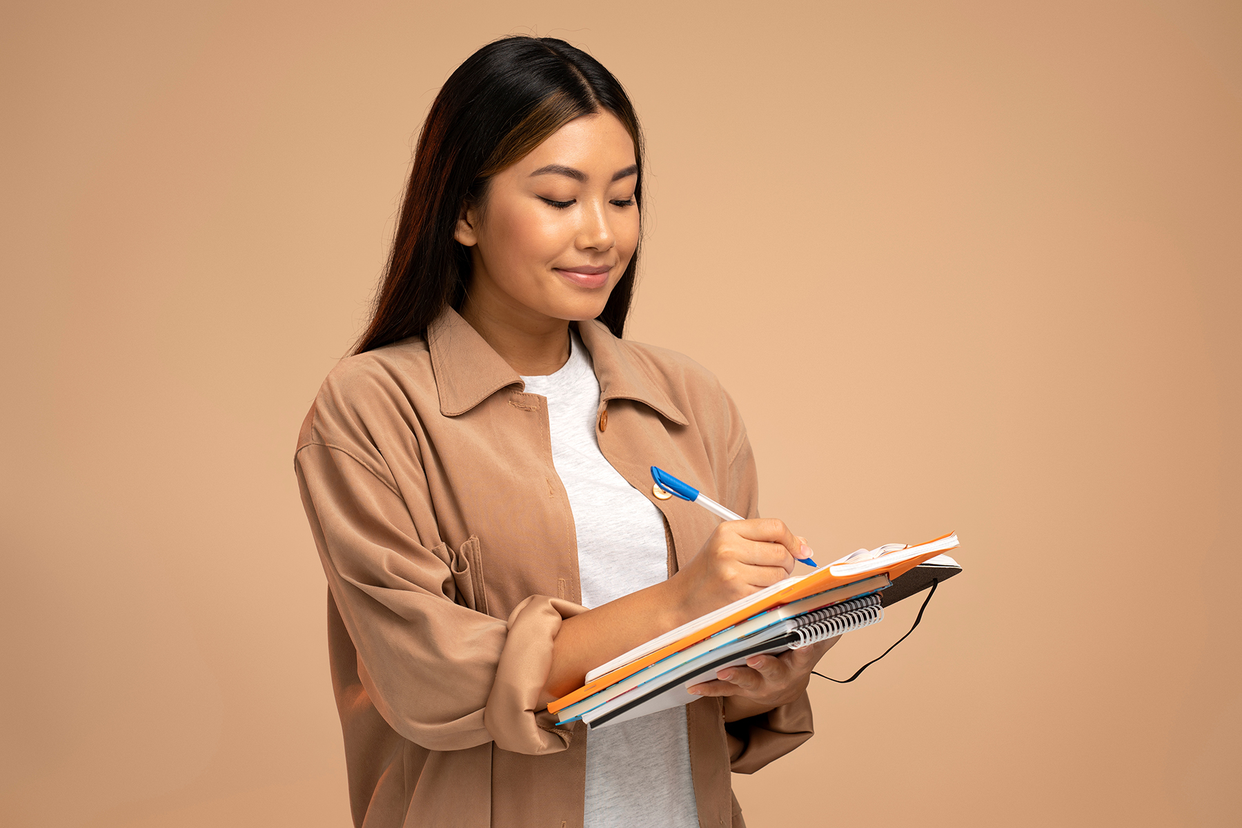 Woman writing notes to plan and organize a custom online store setup with Zamar